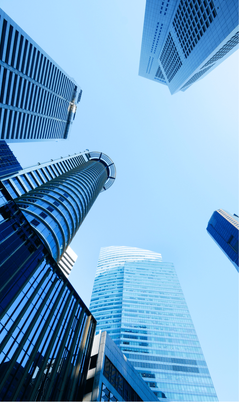A low angle view of Singapore city buildings against blue sky.